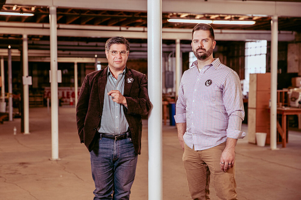 John Farmer de la Torre, left, and David Carr of Ozarks Film Foundry stand in the second floor of the Poplar Street warehouse that's being converted into a media production lab. Plans call for training around set building, prop production and video/lighting rigs.