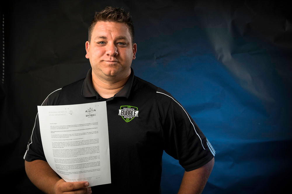 Luke Rogers holds the cease-and-desist letter a Spanish company sent him.