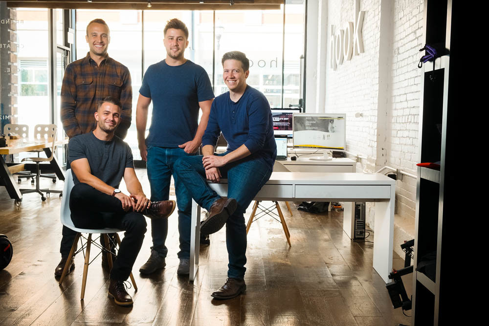 FRIENDS FIRST: Hook Creative’s team describes themselves as a tight-knit group of friends. Pictured, from left, are Bryan Simpson, Nick Stewart, Mark Kelly and, seated, founder Josh Stewart.