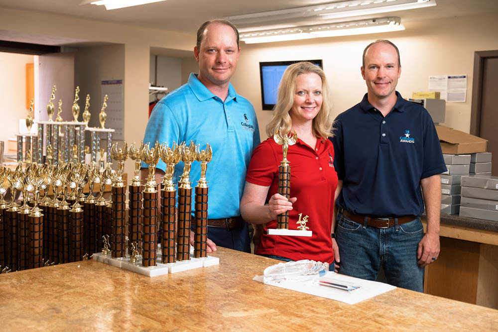 FAMILY TIES: Erin Boster, center, keeps the family tradition of custom fabrication alive at Collegiate Awards, along with her twin brothers Craig and Brad Stout.
