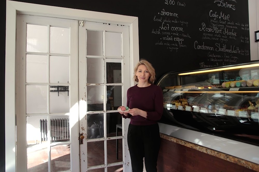 European Cafe co-owner Uliana Komodi stands in front of 100-year-old double French doors leading into the cafe’s new space.