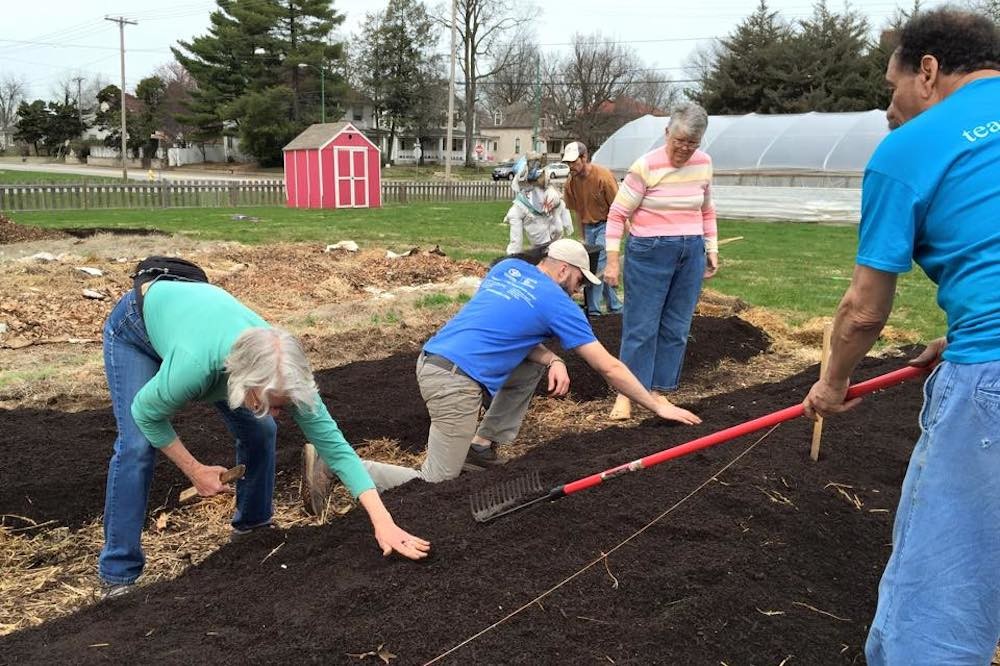 Springfield Community Gardens volunteers work at the nonprofit’s garden near Cox North.
