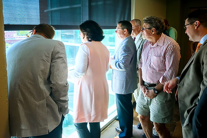 City Council members peer out the seventh floor of Jordan Valley Innovation Center as they discuss potential economic development plans for IDEA Commons.SBJ photo by SYDNI MOORE
