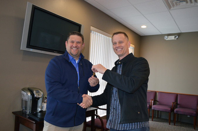 Life360 Park Crest Pastor Ted Cederblom, right, hands over the campus keys to New Covenant Academy Chief Academic Officer Matt Searson.