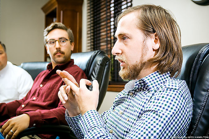 Kurt Theobald, right, gives Chris Olson advice on business plans. Early in the startup process, they might be frivolous, he says.