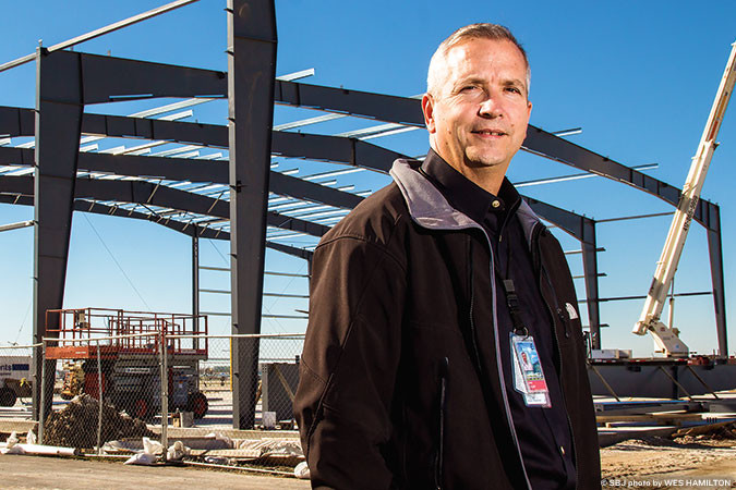 Springfield-Branson National Airport Aviation Director Brian Weiler stands before the airport’s first new hangar in six years, part of a $5.5 million hangar development.