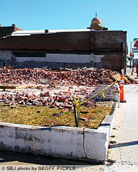 Crews are clearing debris at 511 St. Louis St., where two buildings under the same address were built in 1920.