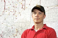 Scott Cribb serves as general manager for Total Highspeed Internet's Nixa office, which is dominated by a surveyor's map of southwest Missouri showcasing tower locations and wireless relay lines.