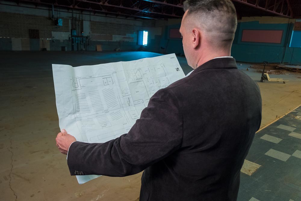 John Stroup reviews plans for Freeway Ministries’ new church inside a former bowling alley.