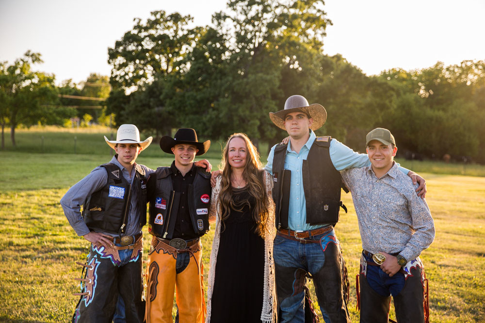 RODEO THEME: Founder Sheri Smith, center, poses with members of her Warriors and Rodeo nonprofit, which serves military veterans and first responders. She says many young vets get into rodeo.