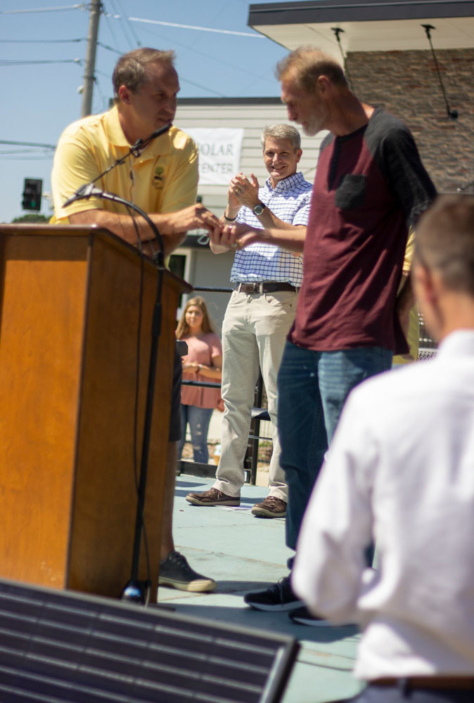 Tiny Homes
Officials host a grand opening Aug. 28 for Eden Village, a development featuring 400-square foot homes for the homeless. Above, Eden Village’s Nate Schlueter presents a house key to new resident Tommy Yarberry.