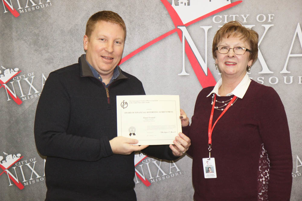 Pinpoint Financials
Nixa Mayor Brian Steele celebrates with Finance Director Donna Swatzell as her department earned a Certificate for Excellence in Financial Reporting for the third straight year from the Government Finance Officers Association of the United States and Canada. Key to the award is demonstrating a constructive “spirit of full disclosure.”