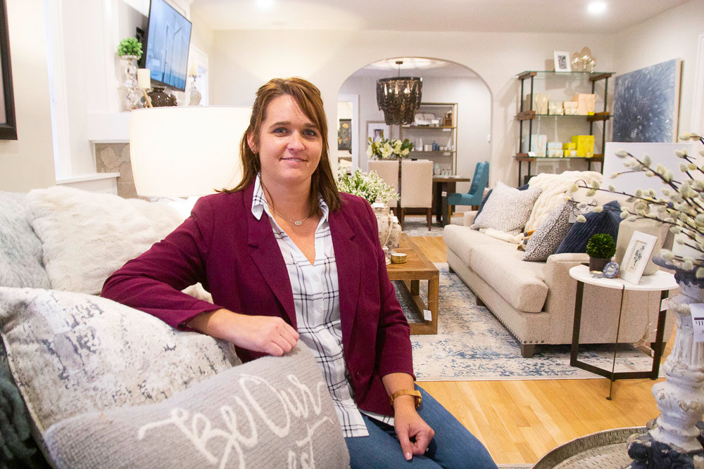 Haden Long sits in the model living room in the new home for Ellecor Design and Gifts.