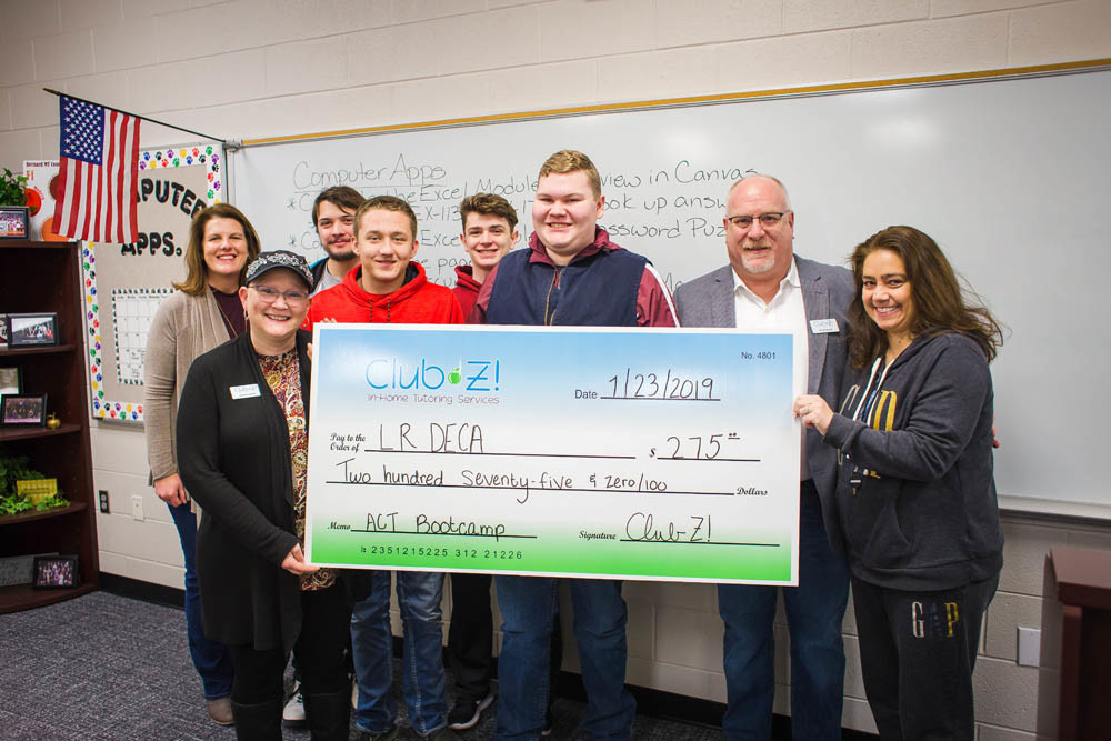 DECA Dollars
Club Z! Tutoring of Springfield on Jan. 23 presents a $275 check to the Logan-Rogersville DECA group. Through the tutoring company’s ACT Boot Camp, Club Z! donates $25 for every student who applies for its ACT workshops. “These boot camps are not only an opportunity for us to prepare students for the ACT, they’re an opportunity for us to do something positive in our area schools,” says Club Z! co-owner Leisha Baker, at far left, holding the check.