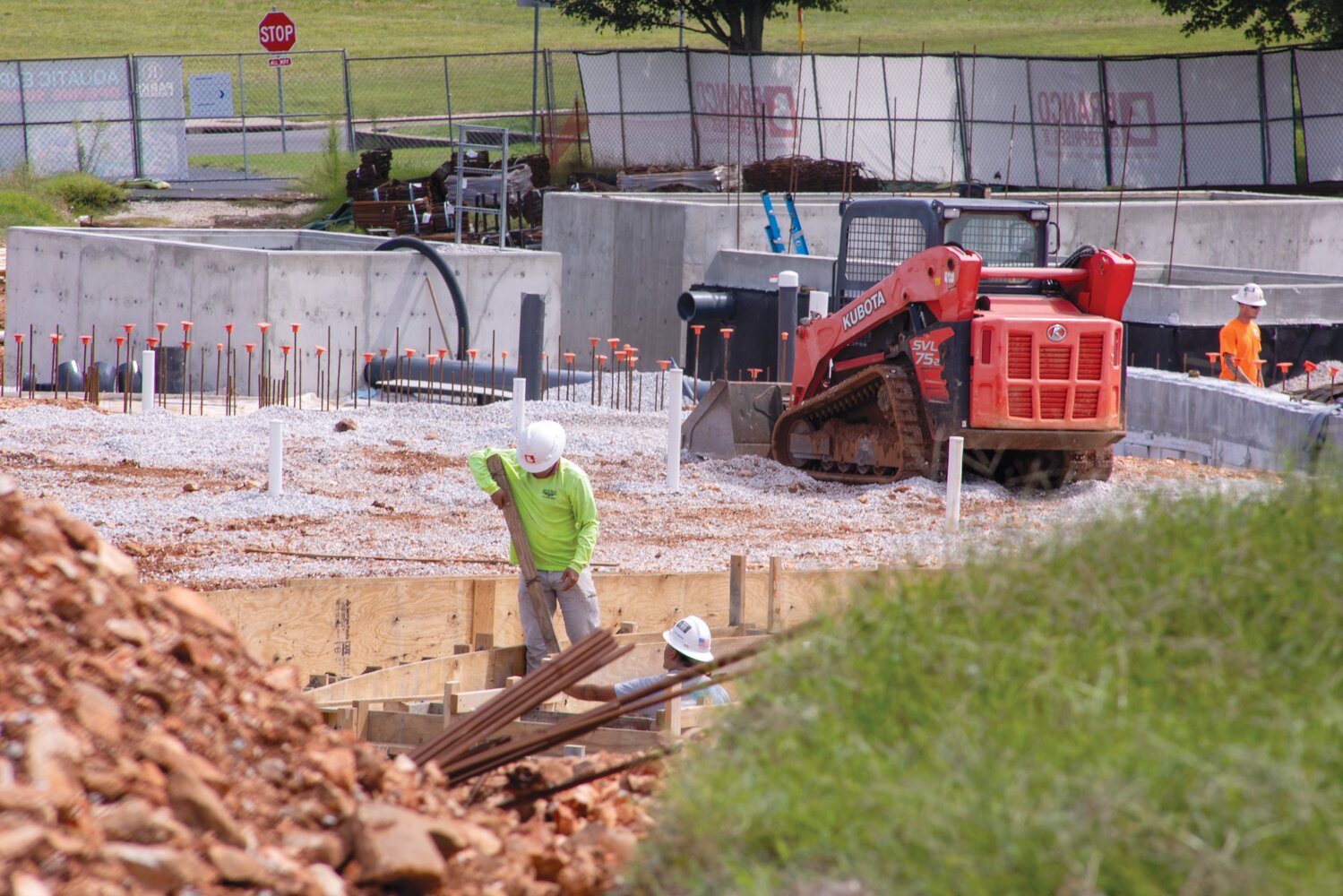 EARNING WAGES: Branco Enterprises Inc. employees work on an expansion project for the Republic Aquatic Center.