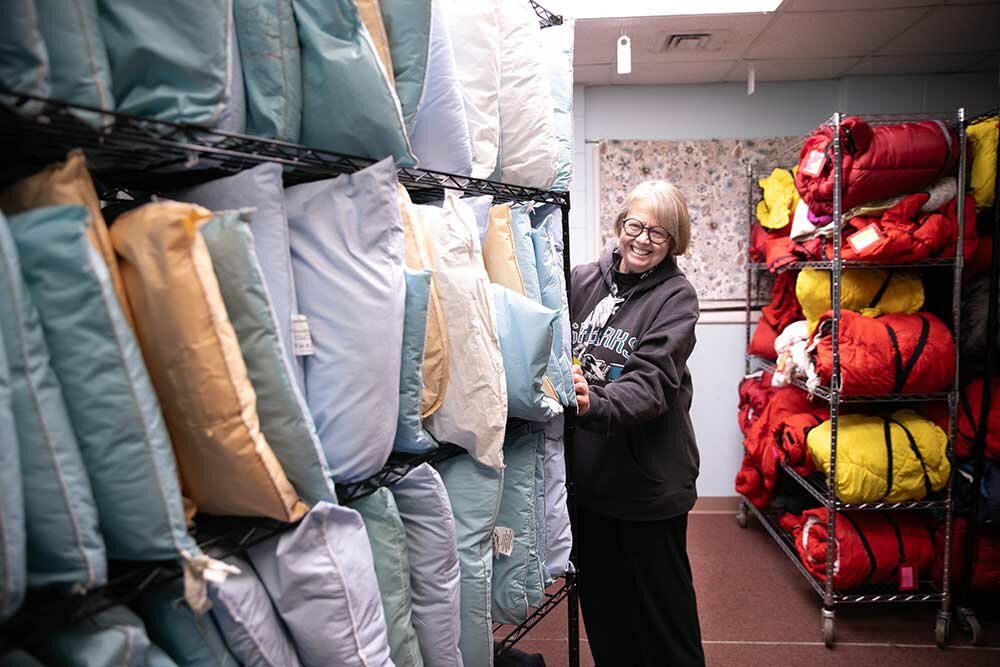 Volunteer Tammy Moody readies the pillows and bedrolls for the night's guests at Safe to Sleep.