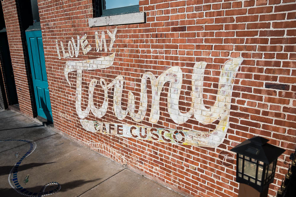 LOCAL TOUCH: A hand-painted sign on Cafe Cusco’s building is remnant of the Towny app.