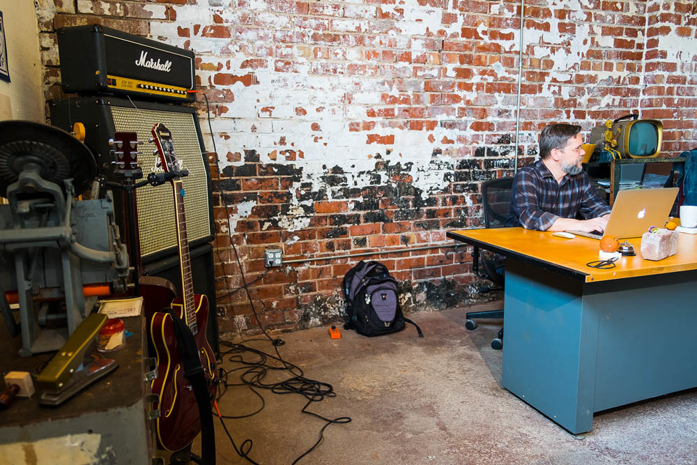 Personal Space
The creative office in the back of the facility shows character from the exposed brick walls and a touch of individuality with McWhirt’s stack of Marshall amplifiers and guitar rack in the corner.