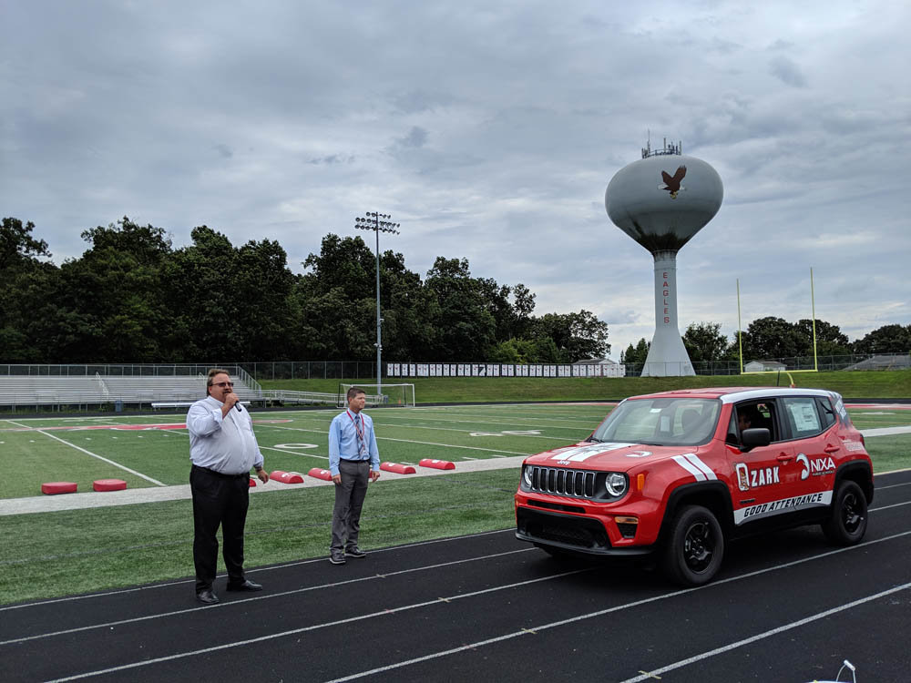 A IS FOR ATTENDANCE
Youngblood Auto Group Managing Partner John Widiger, above, addresses Nixa High School students on their first day of school, Aug. 15.He also visited Ozark High to promote the dealership’s car giveaway for good school attendance. Dubbed The Drive for Attendance, a 2019 Jeep Renegade will be given to one student in a friendly competition between the schools. “It’s all about attendance,” Widiger told the students. Qualifying students can only miss up to four days of school this year, and of those names, 10 each will be chosen in Nixa and Ozark. One name out of the 20 will be chosen at random in May.