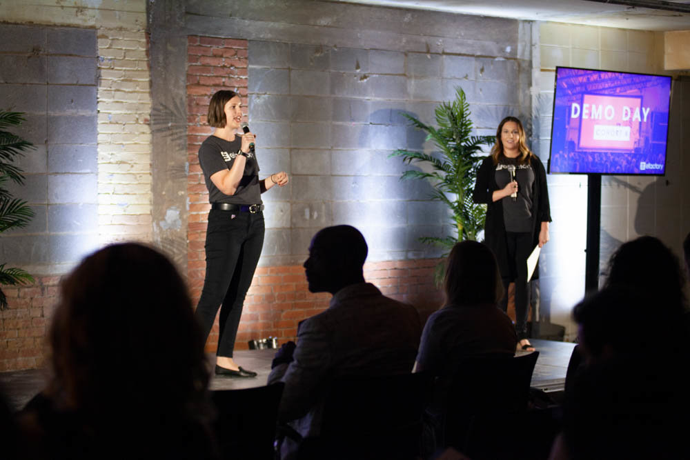 The Efactory’s Paige Oxendine, left, and Rachel Anderson speak during the 2019 business accelerator’s Demo Day event last August.