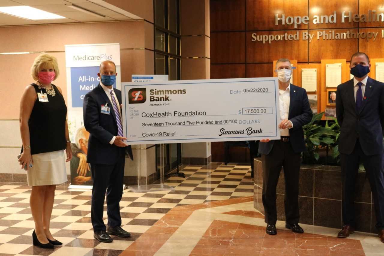 From left, CoxHealth Foundation President Lisa Alexander and CoxHealth CEO Steve Edwards accept a check from Simmons Bank executives Doug Parker and Alan Perryman.