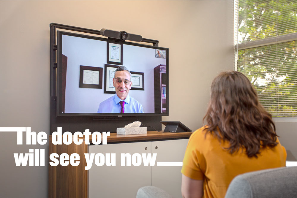 Dr. Shahid Kaous with Burrell Behavioral health demonstrates a telehealth visit with a staff member. In the last few months, the health system has been conducted 70%-85% of visits over video and telephone.