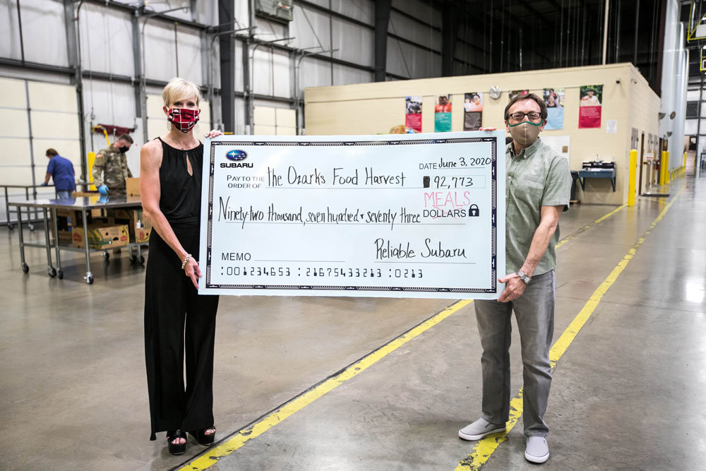 WHEELS FOR MEALS
Reliable Subaru Marketing Director Rebecca Pottebaum,  far left, makes a presentation to Ozarks Food Harvest CEO Bart Brown for 92,773 meals. Pottebaum says the car dealership raised the donation for the food bank through the Subaru Love Promise campaign.