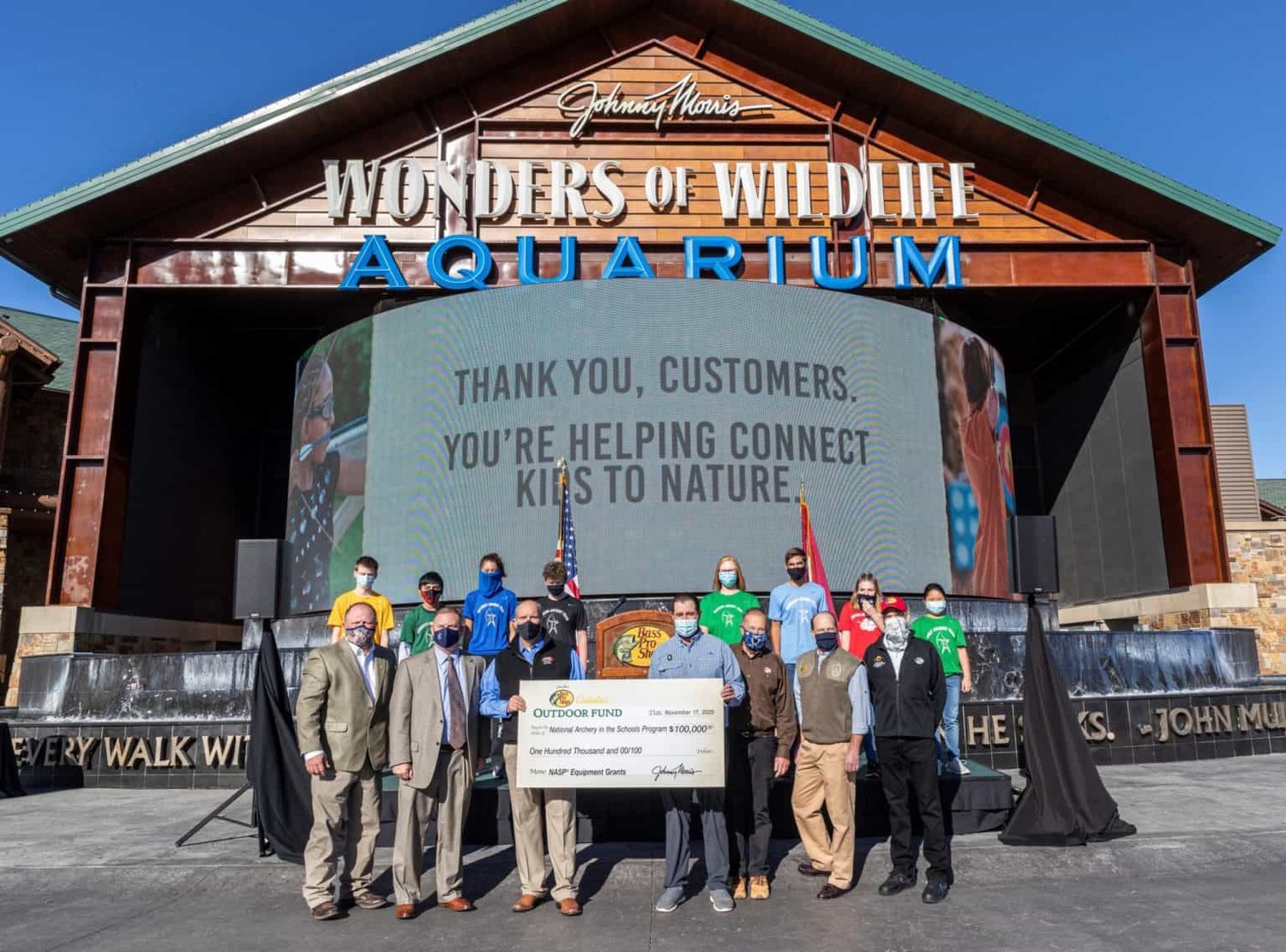 Bass Pro Shops officials present a $100,000 check for the National Archery in the Schools Program.