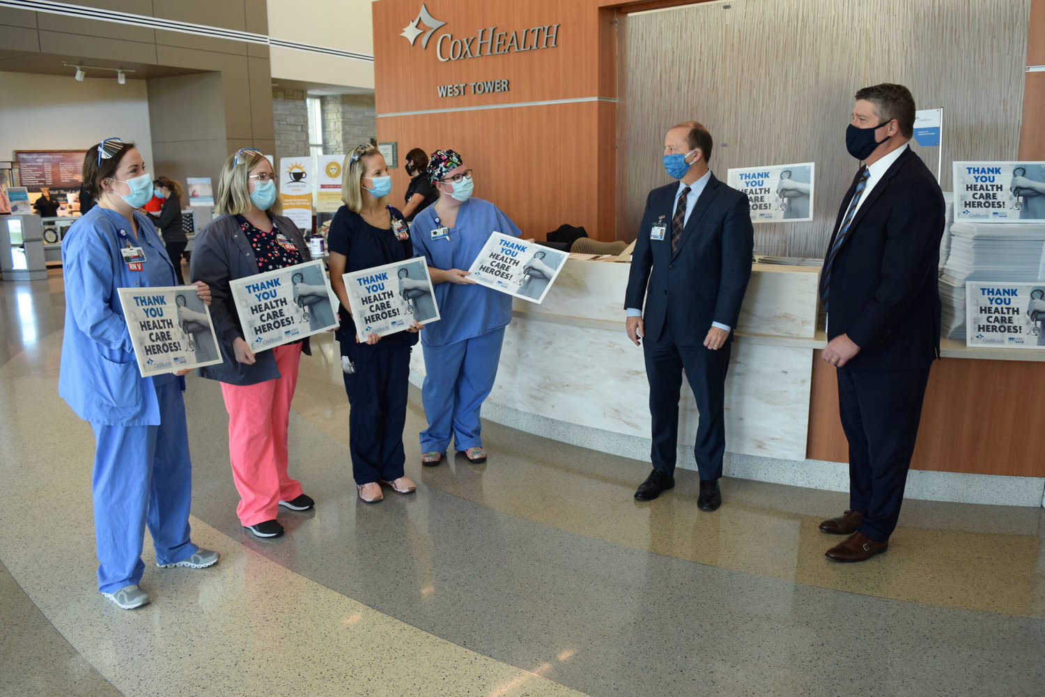 ‘HEALTH CARE HEROES’
CoxHealth workers hold signs presented by Springfield First Community Bank CEO Monte McNew, far right, on Feb. 19. The bank has donated 5,000 signs that say “Thank you, Health Care Heroes” for hospital employees, including CoxHealth President and CEO Steve Edwards, center, to pick up and display in their yards. “SFC Bank is especially grateful for the time, energy and expertise given by these front-line workers and those that support them,” McNew said in a news release.
