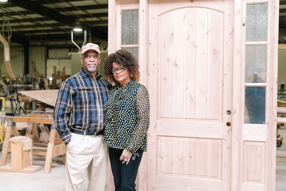 Jamerson Doors owners Lamarr Jamerson Sr. and Deborah Jamerson stand in their workshop where custom wooden doors are made. They sell for $1,000-$14,000 apiece.