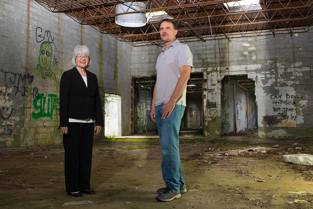 DUE FOR DEMOLITION: Crane Mayor Collin Brannan, pictured with former City Clerk Beth Murphy, who helped the town apply for state grants last year, wants to seek demolition bids for a long-shuttered casket factory.