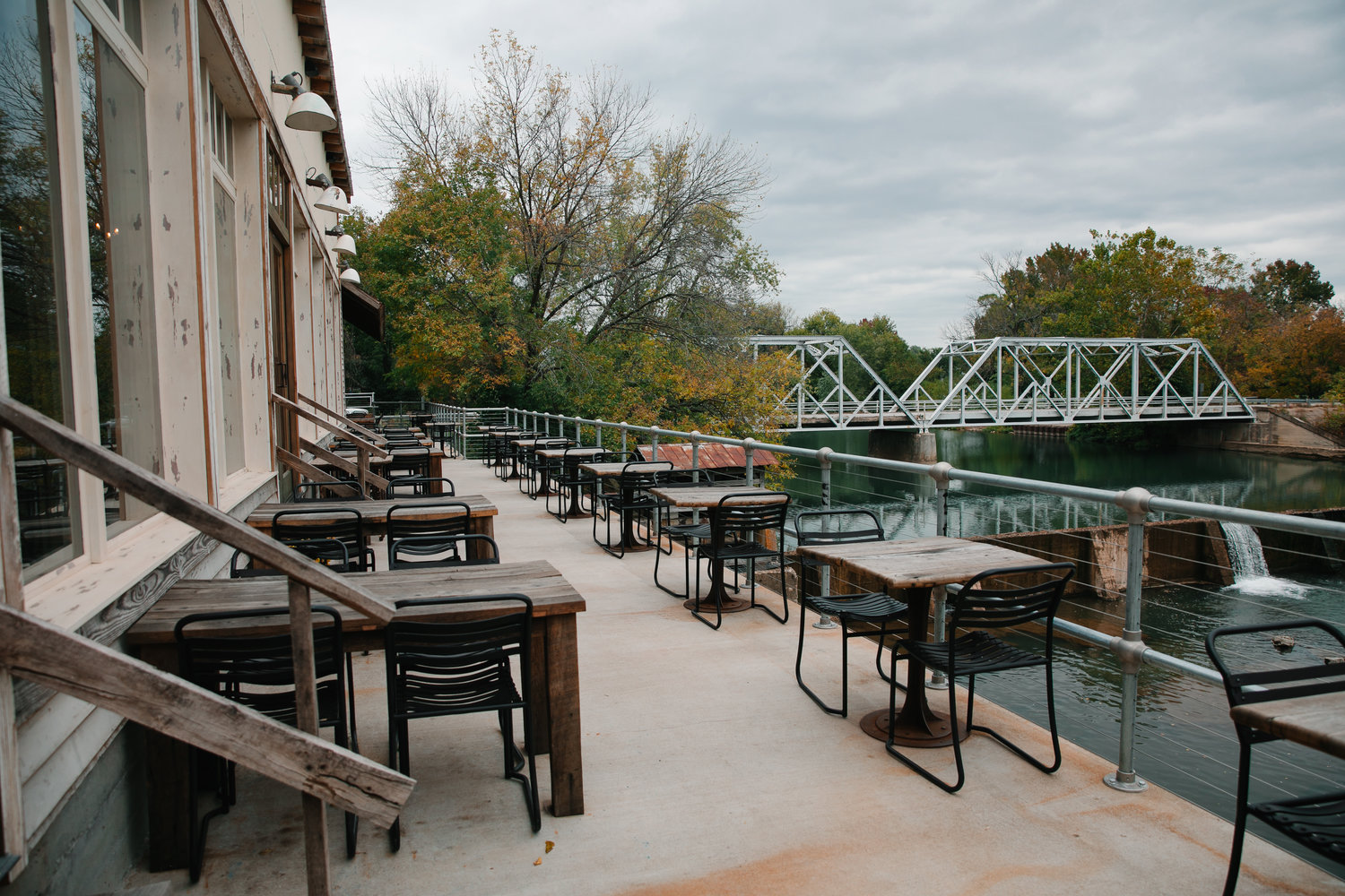 Outside diners at The Ozark Mill Restaurant have views of the Finley River and Riverside Bridge.