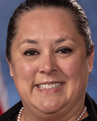 Angela Romine prefers to see spending plan before voting on grant funds.
