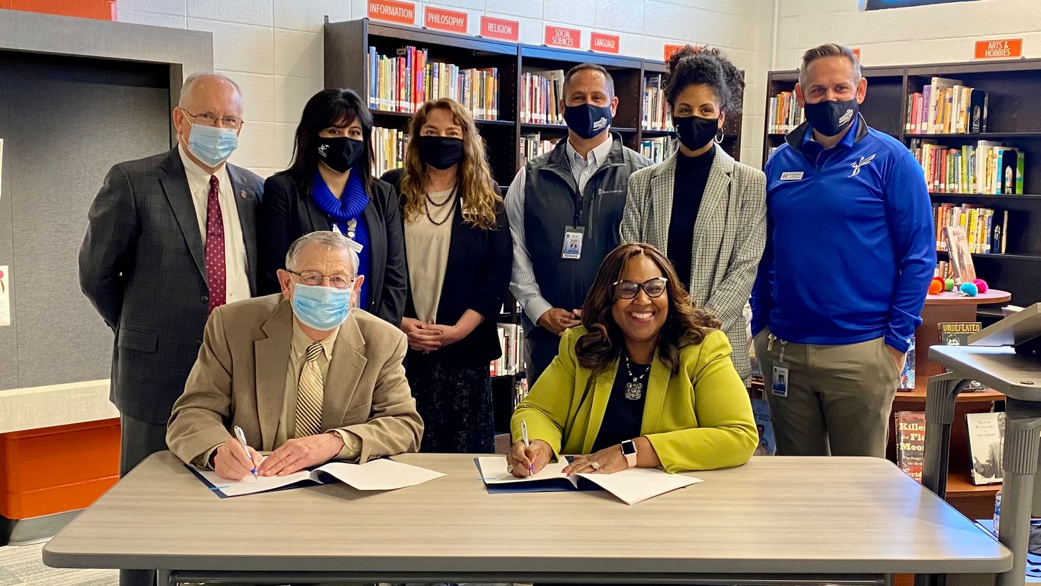 Seated, MSU Provost Frank Einhellig and SPS Superintendent Grenita Lathan sign a memorandum of understanding with other representatives of the organizations in attendance.