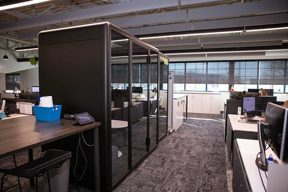 Two soundproof office pods are positioned in the middle of the studio. Erwin says the booths, made of a powder-coated metal frame and tempered safety glass, provide room for employees to conduct phone calls, focus more intently on their work or take a break. They also have proven a convenient spot for staff to place doodles they create on sticky notes.