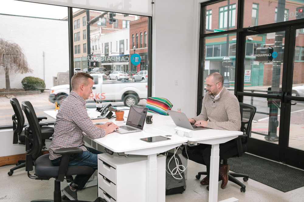 There’s no executive suite in the office. Paulette and David Church, two of the firm’s partners (with the other, Larry Paulette, not pictured) share the open-concept workspace with the company’s graphic designers, web developers and content specialists.