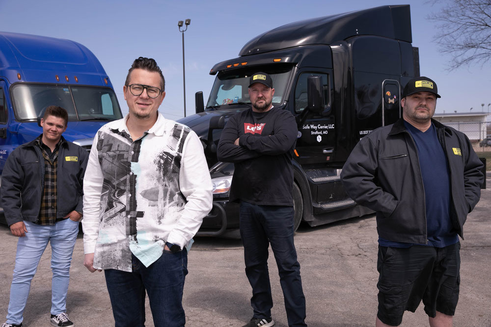 Bogdan Golosinskiy (front), owner of Safe Way Carrier, took his trucking expertise to Ukraine to help with the relief effort. His company, some 125 strong, had his back. With him are Safe Way team members (from left) Williams Hunter, Ricky Ray and Alex Berkovich.
