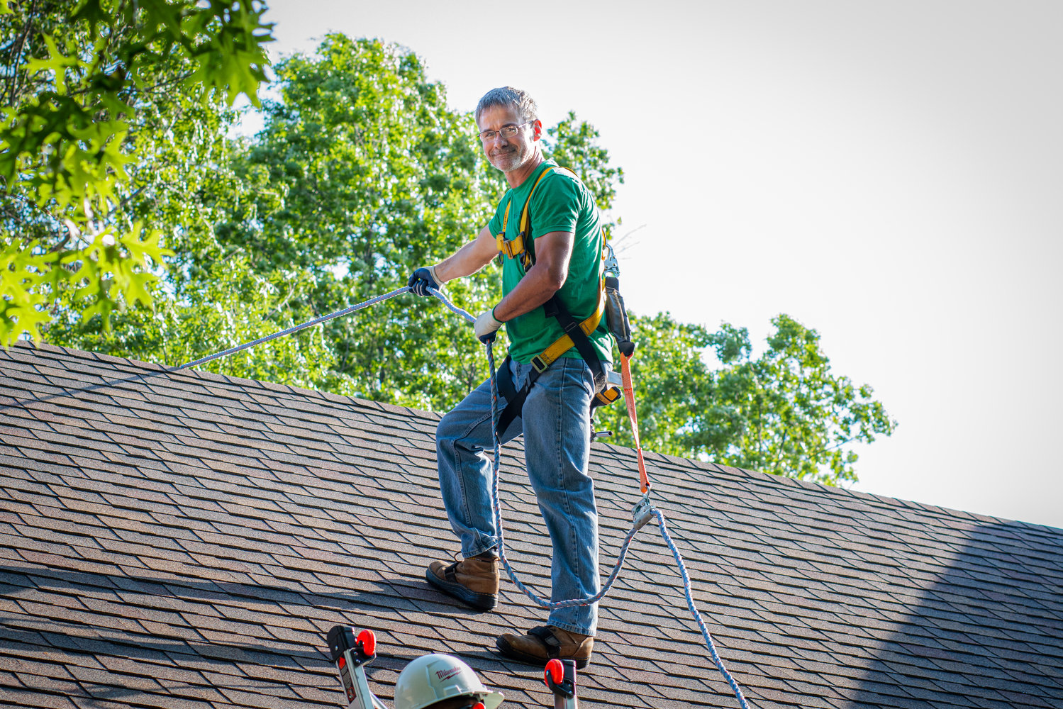 UNDER MAINTENANCE: Tom O'Connor with Solera Energy ascends the roof of a customer's home for a solar panel maintenance check.