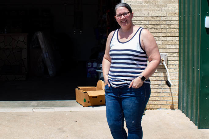 Christie Love, pastor of The Connecting Grounds, stands in front of the donation area in the back of the church's outreach center.