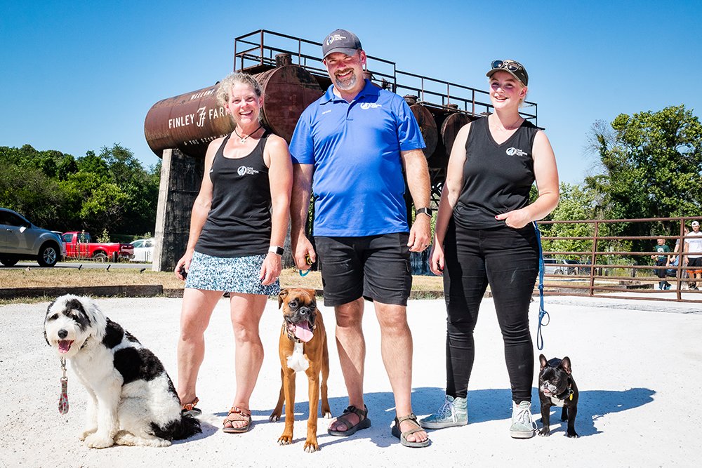 FAMILY INVESTMENT: Joined by their dogs, from left, Gidget, Otto and Ethel, husband and wife Jeremy and Kristi Aderson, along with daughter Nerissa, far right, are involved in a pair of canine-related business franchises.