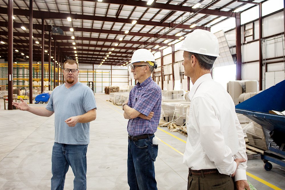 On the company's third day in its new plant, Joel Caler, left, HR representative for Lippert Components, gives a tour to landlords Joe, center, and Eric Roberts, co-owner of Roberts Industrial Properties.