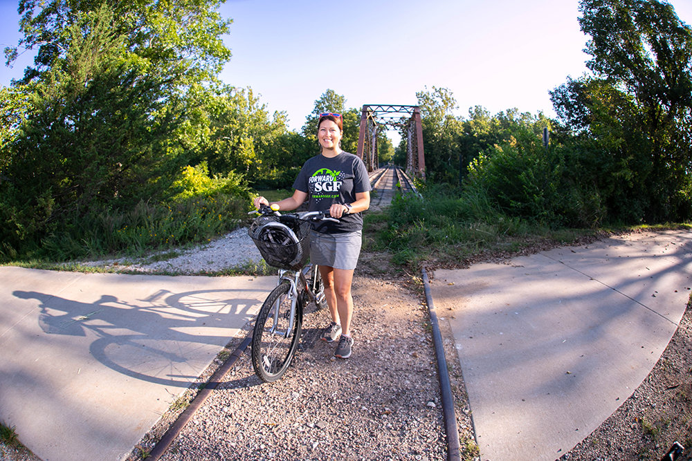 Mary Kromrey, executive director of Ozark Greenways, pauses in her ride at a point on the James River Trail where it intersects with the planned expansion of the Chadwick Flyer Trail to connect Springfield with Ozark.