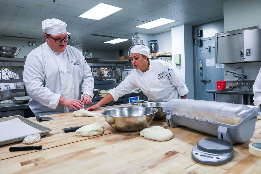 CULINARY INSTRUCTION: Students get instructions on bread making during a lab session in the culinary arts program at Ozarks Technical Community College.