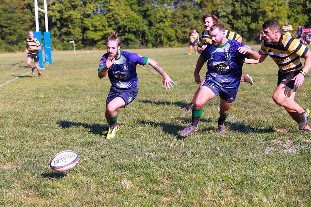 ON THE PITCH: Players scramble for the rugby ball during a recent match at their new facility, 4035 E. Sawyer Road in Brookline.