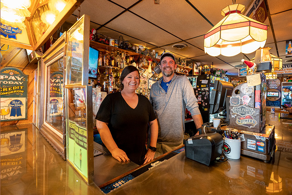 The Flea Manager Mandy Motsinger and co-owner Grady Wisdom offer a warm welcome to a bar with a thrifting atmosphere.