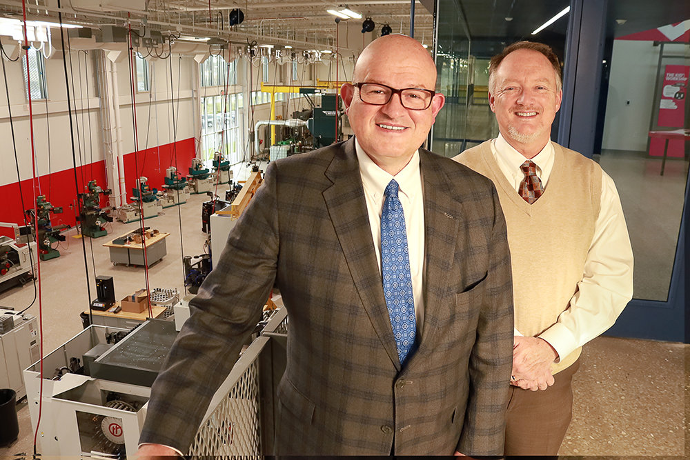 OTC Chancellor Hal Higdon, left, and Vice Chancellor of Administrative Services Rob Rector have a view of the work floor of the new Plaster Center for Advanced Manufacturing, which includes 15,000 feet of industry partner space.
