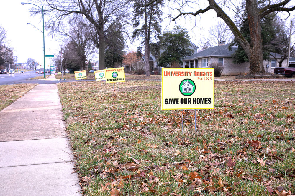 A University Heights homeowner displays a series of signs on the west side of National Avenue, just north of the Sunshine Street intersection. "Save Our Homes" is the slogan adopted by opponents to a proposed development there.