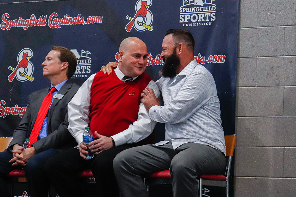 SOMETHING TO SQUAWK ABOUT: Springfield Cardinal General Manager Dan Reiter (center) is congratulated by St. Louis Cardinals veteran pitcher Josh Kinney on a proposed purchase of the Cardinals' home, Hammons Field, by the city. City Manager Jason Gage also is pictured.