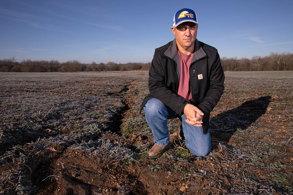 REGULATED WATERS?: Trent Drake, president of Polk County Farm Bureau, looks out at a field where running water poses a problem. Under the latest EPA definition, it may be a federally regulated water of the United States.