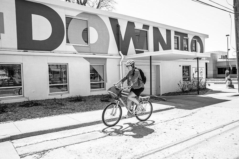 COUNT THE MILES: Mary Kromrey rides to her Ozark Greenways office, which is in the downtown CID building across from historic City Hall.